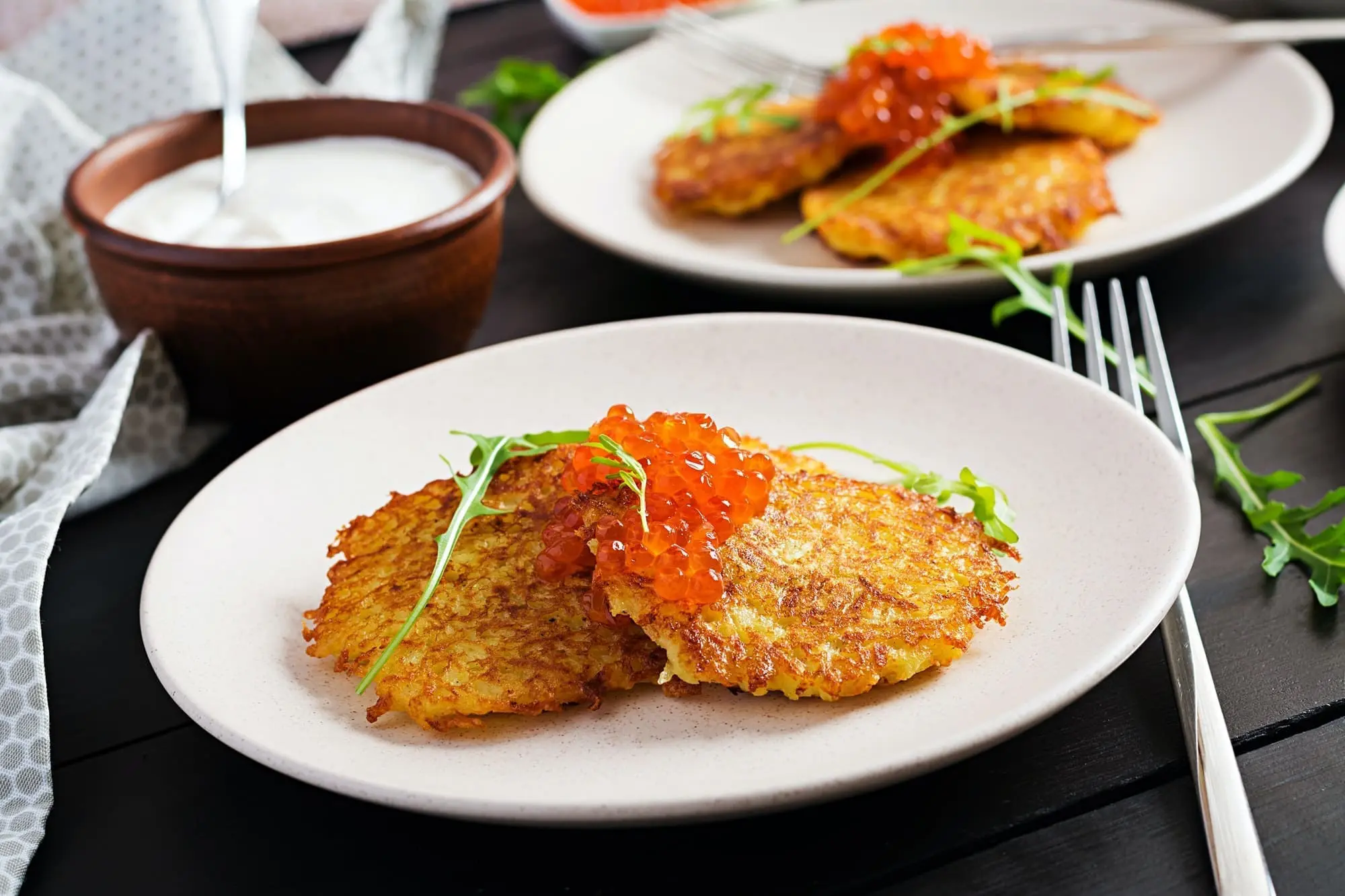 Fried potato pancakes with red caviar and sour cream, fritter, roesti
